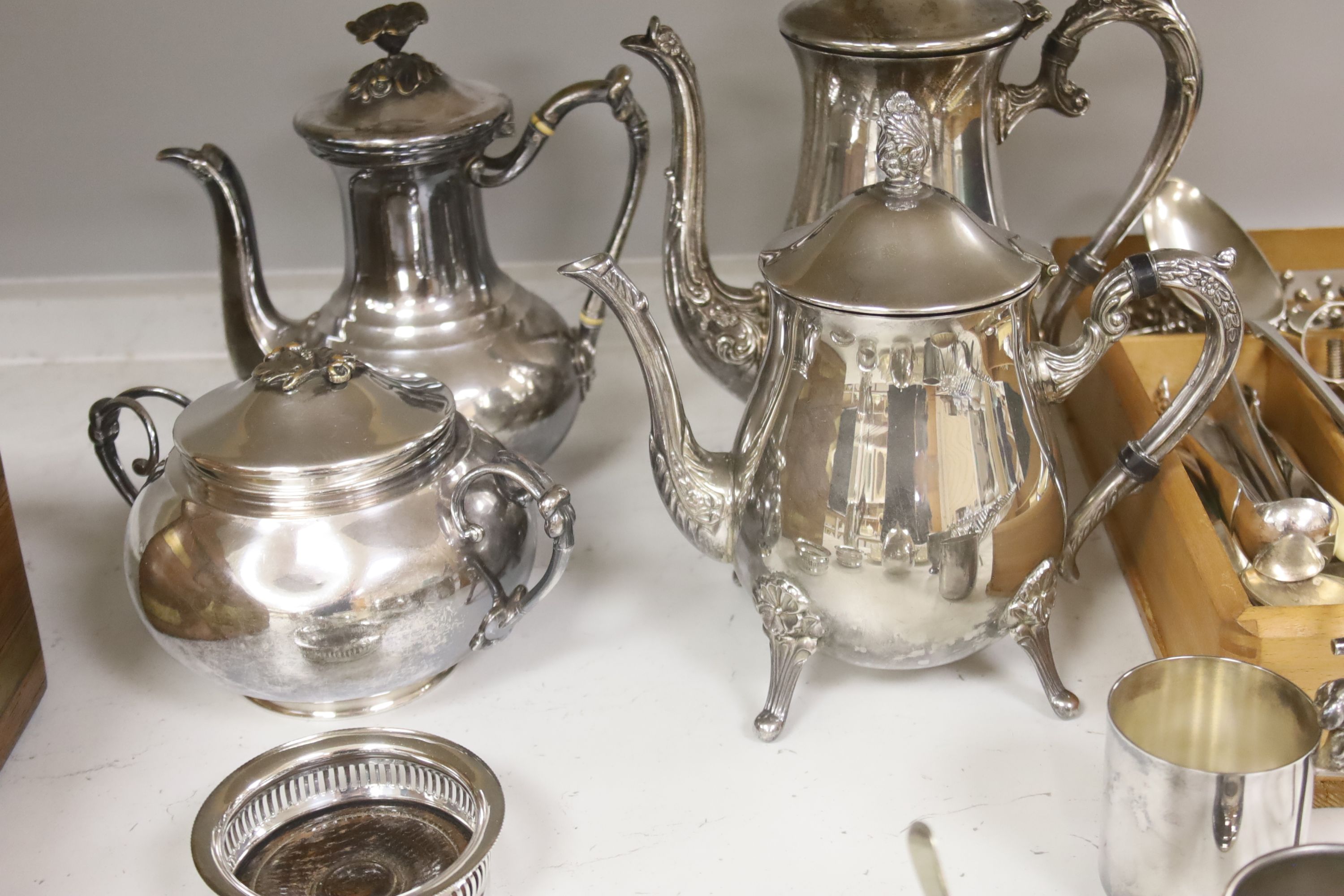 A group of assorted plated wares including a set of four gilt salts and a butter dish